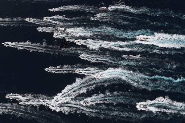 Supermaxi Black Jack, surrounded by spectator craft, leads the fleet down the coast in the 2017 Sydney to Hobart Yacht.