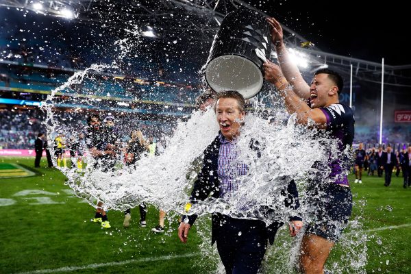 Melbourne Storm coach Craig Bellamy is drenched with iced water after his team won the 2017 NRL Grand Final against the North Queensland Cowboys in Sydney.