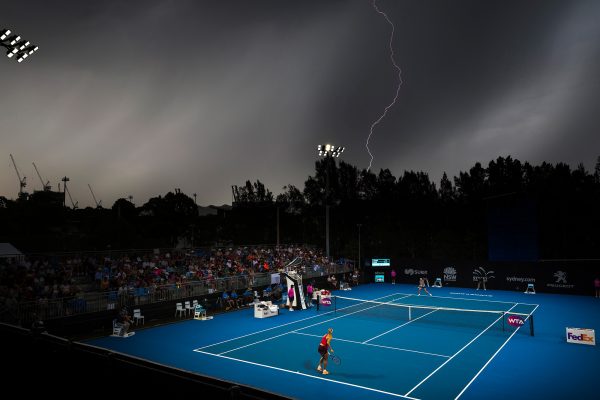Angelique Kerber of Germany smashes an ace down to Czech Republic’s Lucie Safarova as lightning strikes at the Sydney International Tennis Tournament at Sydney Olympic Park Tennis Centre.