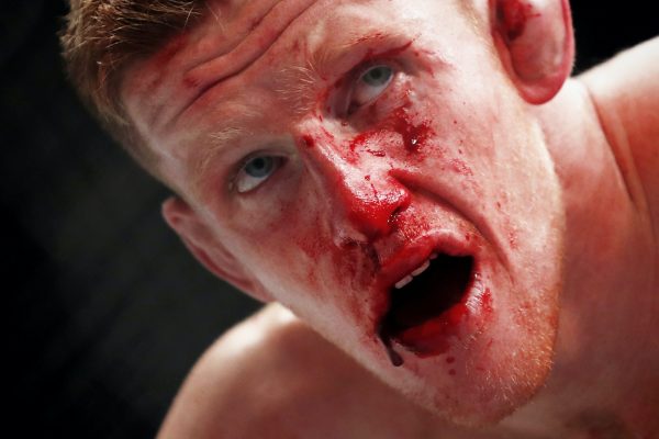 Australian fighter Jamie Mullarkey catches his breath at the end of his fight with Brad Riddell.